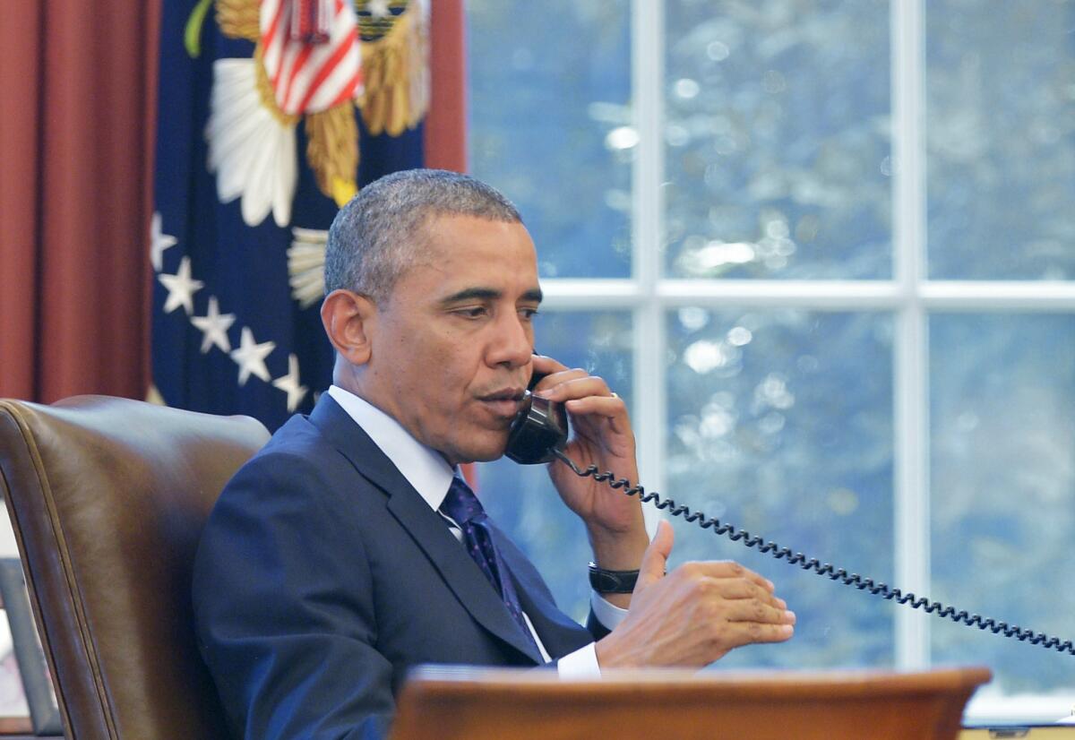 President Obama speaks on the phone during a conference call hosted by public health groups on Monday in the Oval Office in Washington.