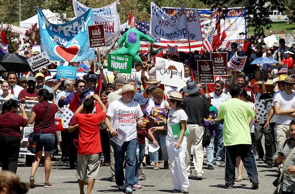 Thousands of pro-immigration demonstrators join a "Path to Citizenship" rally at Yokuts Park in Bakersfield.