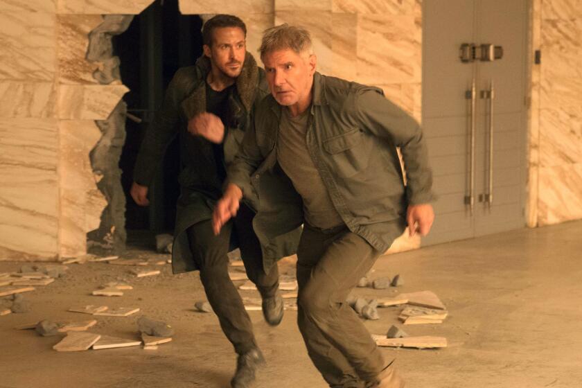 This image released by warner Bros. Pictures shows Ryan Gosling, left, and Harrison Ford in a scene from "Blade Runner 2049." (Stephen Vaughan/Warner Bros. Pictures via AP)