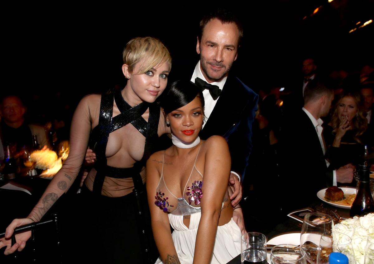 Miley Cyrus, left, and Rihanna with honoree Tom Ford at the amfAR L.A. Inspiration Gala.