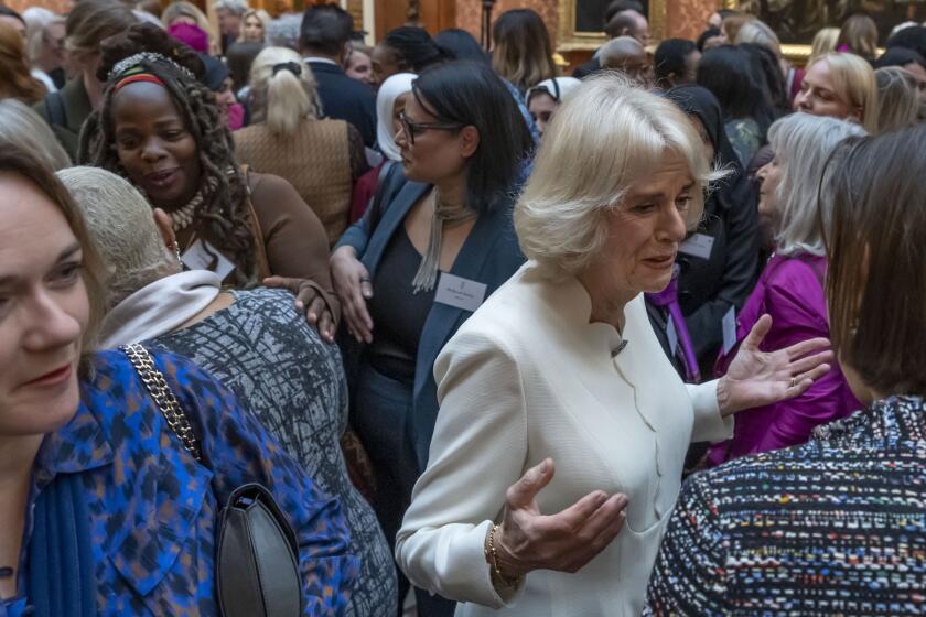 FILE - Charity leader Ngozi Fulani, centre left, attends a reception held by Britain's Camilla, the Queen Consort to raise awareness of violence against women and girls as part of the UN 16 days of Activism against Gender-Based Violence, in Buckingham Palace, in London, Tuesday Nov. 29, 2022. An honorary member of the Buckingham Palace household has resigned after repeatedly asking a Black woman who runs a charity for survivors of domestic abuse what country she “really came from.’’ The conversation was detailed on Twitter by Ngozi Fulani, chief executive of Sistah Space, an east London refuge that provides specialist support for women of African and Caribbean heritage. (AP Photo/Kin Cheung, Pool, File)