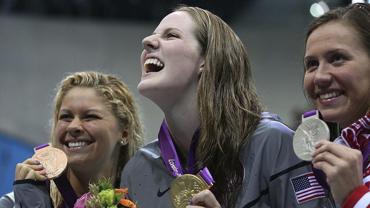 U.S. swimmer Missy Franklin, center, celebrates her gold-medal win in the women's 200-meter backstroke at the London Olympics in 2012.