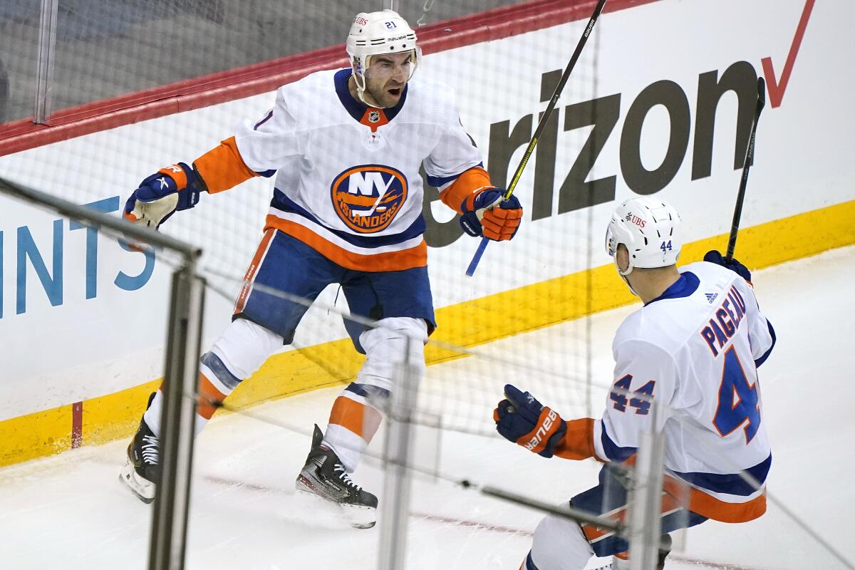 New York Islanders' Kyle Palmieri celebrates with Jean-Gabriel Pageau after scoring.