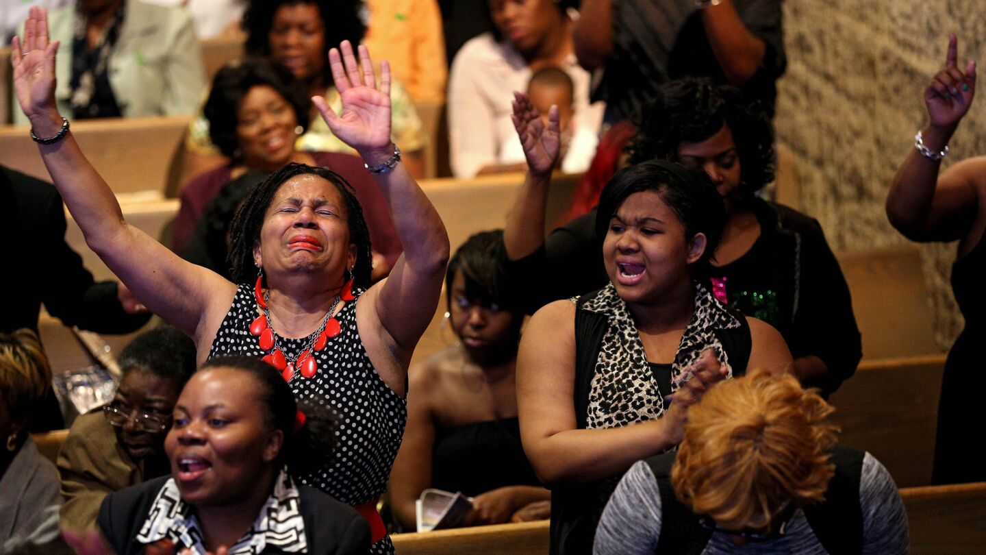 Church members sing and pray at the Southern Baptist Church with pastor Dr. Donte L. Hickman Sr., (not pictured) two days after Baltimore authorities released a report on the death of Freddie Gray on May 3, 2015 in Baltimore. Maryland Gov., Larry Hogan called for a statewide "Day of Prayer and Peace" on Sunday.