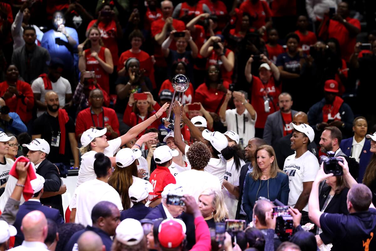 Members of the Washington Mystics celebrate after defeating the Connecticut Sun to win the 2019 WNBA Finals on Oct. 10.
