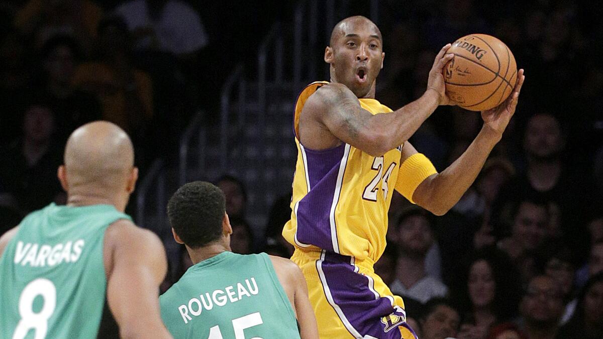 Lakers guard Kobe Bryant looks to make a pass during an exhibition game against Maccabi Haifa on Oct. 11.