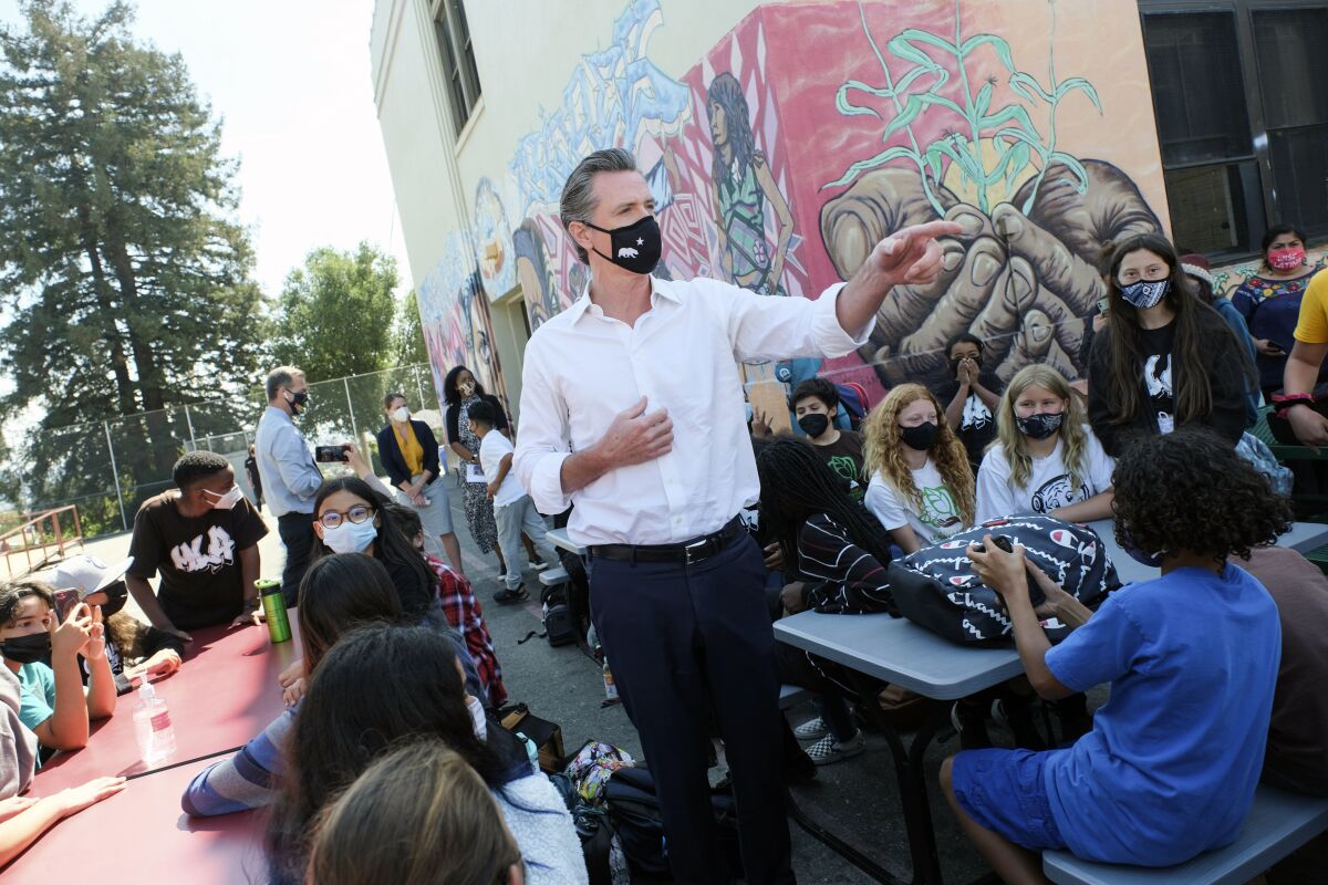 Gov. Gavin Newsom meets with students at Melrose Leadership Academy, a TK-8 school in Oakland, Calif., on Wednesday, Sept. 15, 2021, one day after defeating a Republican-led recall effort. The recall election that once threatened Newsom's political career has instead given it new life. (AP Photo/Nick Otto)