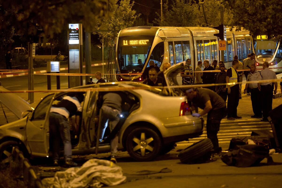 Israeli police officers in Jerusalem inspect the scene where a vehicle driven by a Palestinian man crashed into a crowd, fatally injuring a 3-month-old girl.