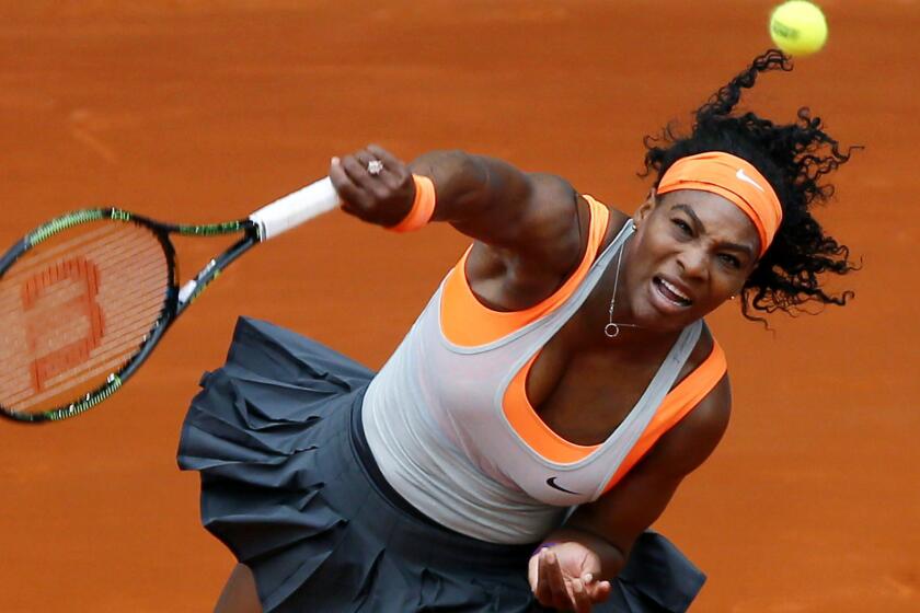 Serena Williams hits an overhead shot during her match against Madison Brengle on Sunday in Madrid.