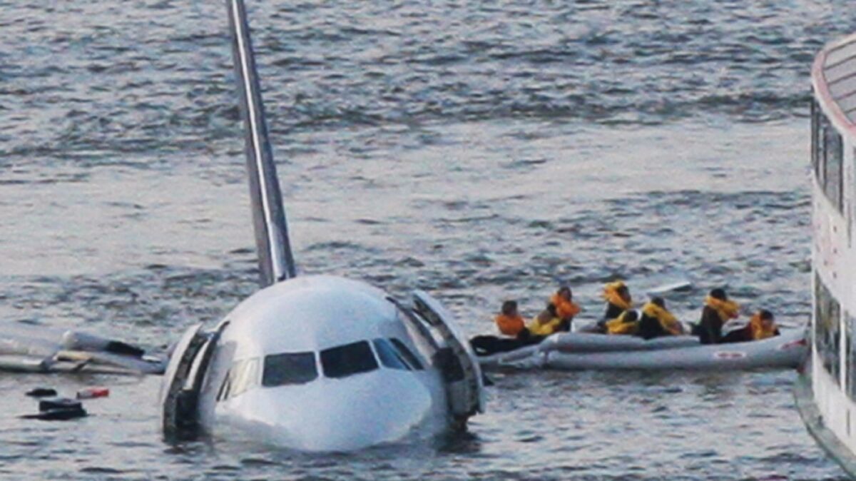 A raft leaves the US Airways jet that landed on the Hudson River in New York on Jan. 15, 2009. American Airlines helped Clint Eastwood film his movie on the crash and its aftermath, but won't show it on flights.