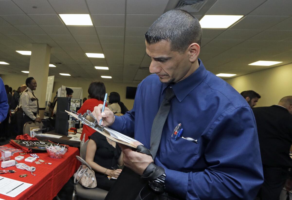 Fareed Farraj fills out a job application at the Veterans Career and Resource Fair in Miami on Feb. 6.