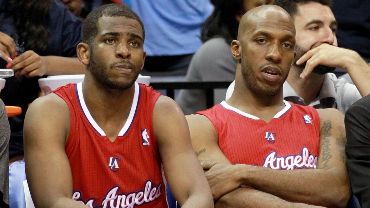 Chris Paul, left, and Chauncey Billups sit on the Clippers bench in 2013.