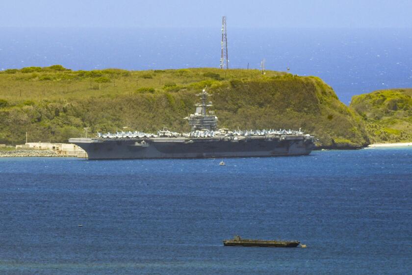 FILE - In this April 3, 2020, file photo, the USS Theodore Roosevelt, a Nimitz-class nuclear powered aircraft carrier, is docked along Kilo Wharf of Naval Base Guam. People in Guam are used to a constant U.S. military presence on the strategic Pacific island, but some are nervous as hundreds of sailors from the coronavirus-stricken Navy aircraft carrier flood into hotels for quarantine. Officials insist they have enforced strict safety measures. (Rick Cruz/The Pacific Daily via AP, File)