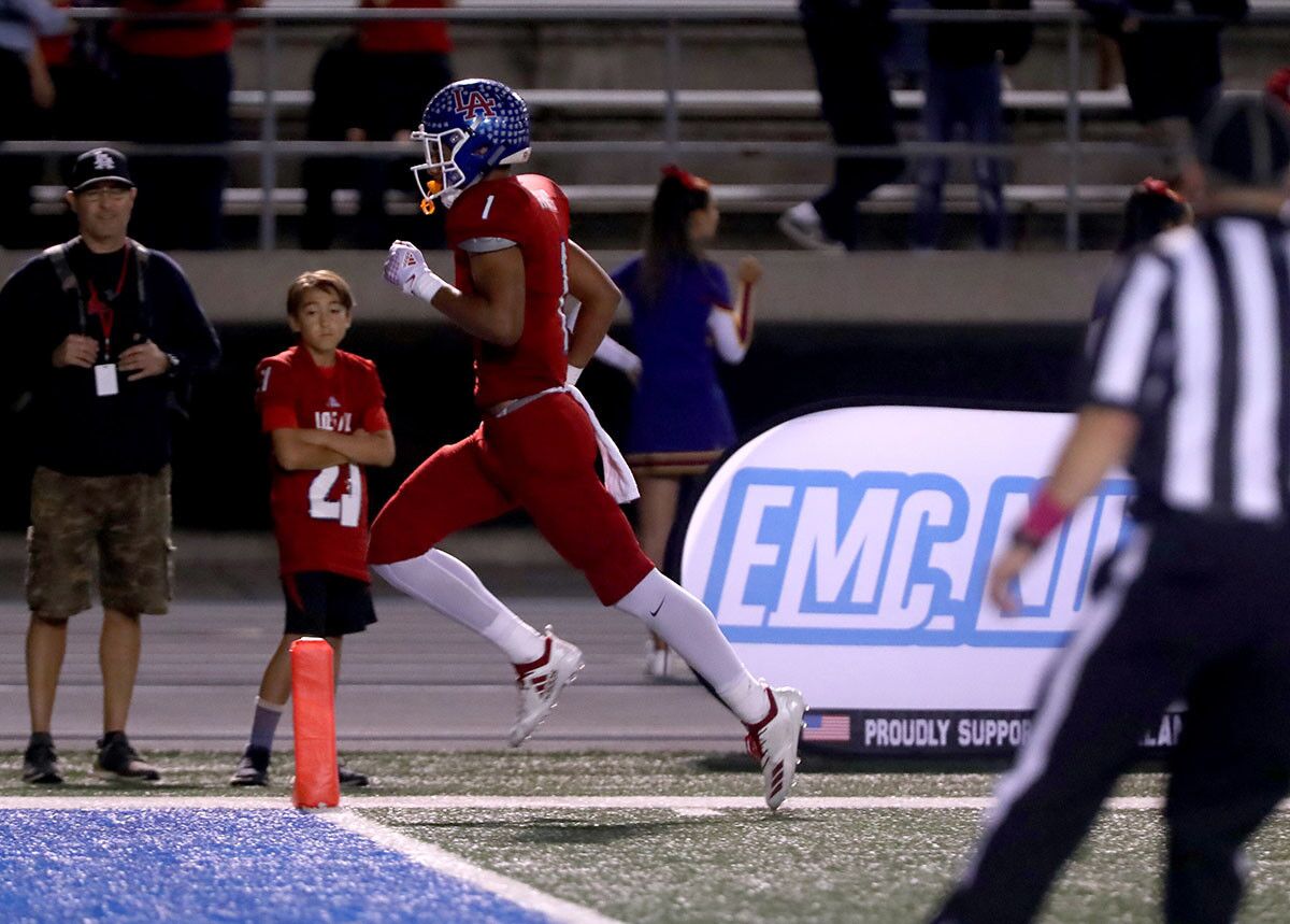Los Alamitos High School football player #1 Demario King scores a TD in home game vs. Newport Harbor High School at Cerritos College in Norwalk on Friday, Oct, 5m 2018. NHHS lost 7-42.
