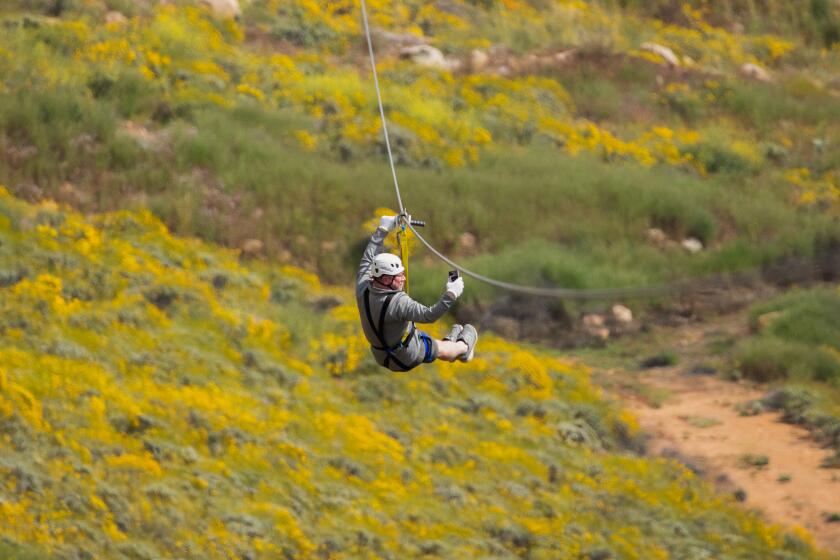 CORONA, CA - APRIL 17: Elias Dau of Orange County takes a selfie while celebrating his 50th birthday above the superbloom at Skull Canyon Zipline in Corona on Monday, April 17, 2023 in Corona, CA. (Myung J. Chun / Los Angeles Times)