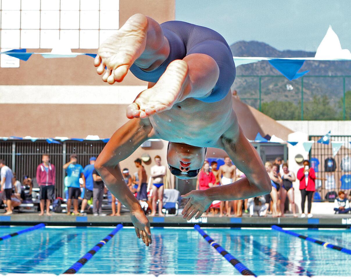 Crescenta Valley's Edward Yi takes off from the starting block in the championship final of the 200 yard freestyle, a race he wins, in the Pacific League swimming finals at the Burbank High School pool on Thursday, May 8, 2014.