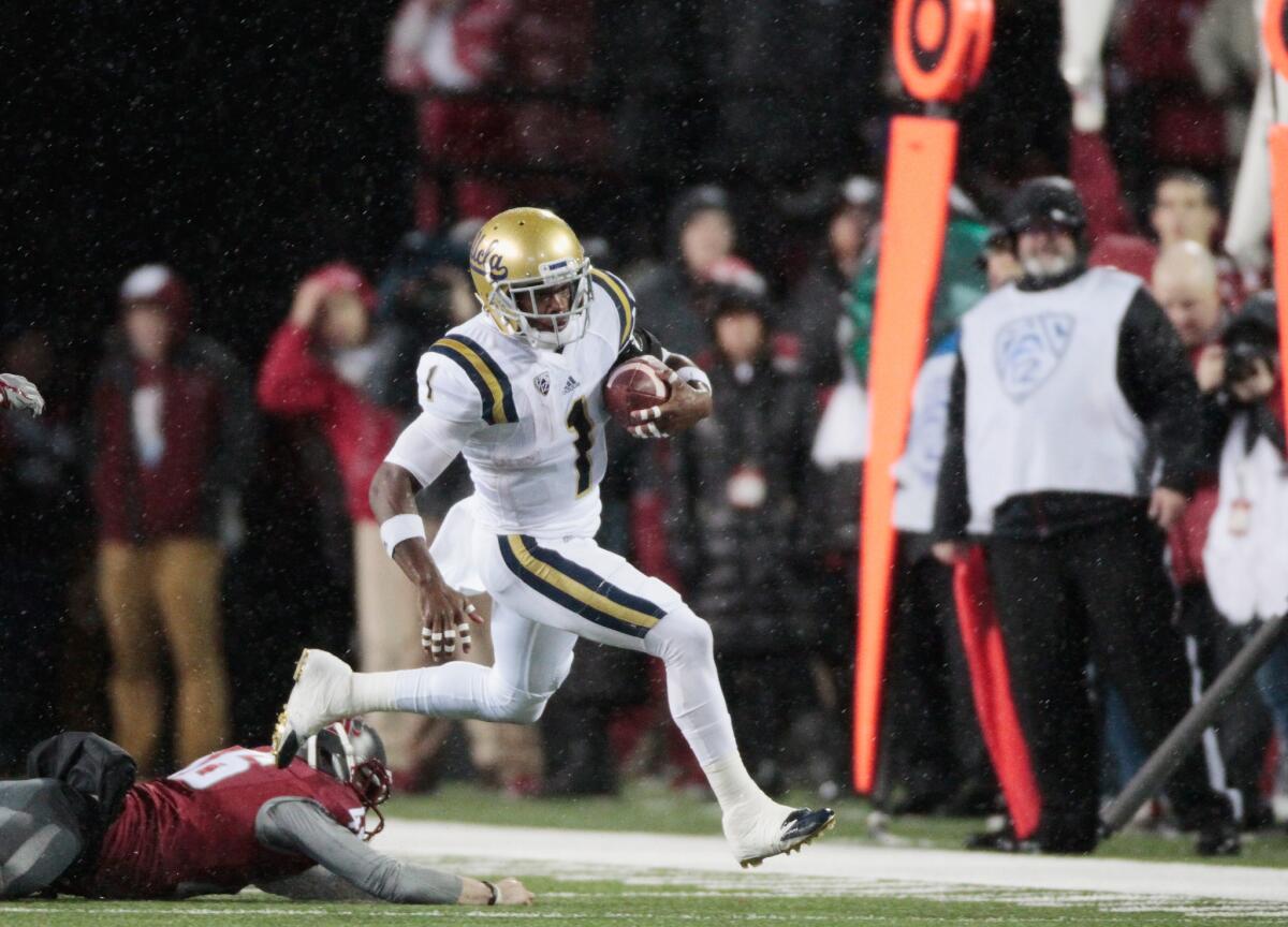 UCLA receiver Ishmael Adams carries the ball past Washington State punter Erik Powell during a game on Oct. 15.