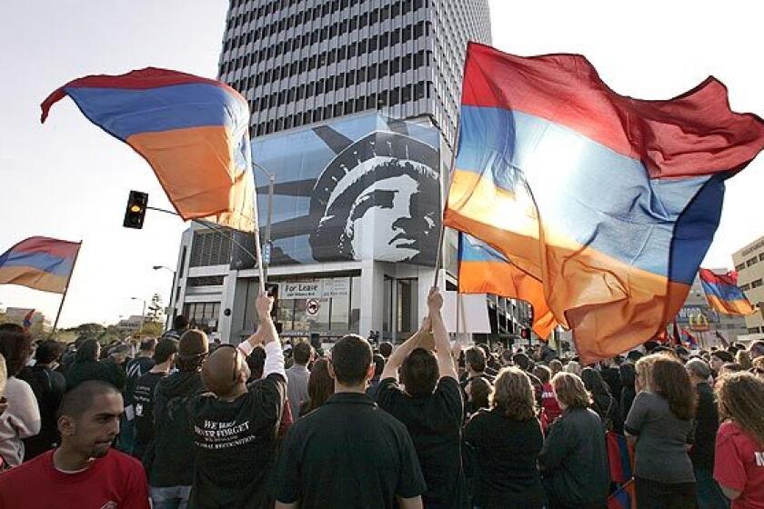 Protesters wave the Armenian flag during a demonstration outside the Turkish Consulate on Wilshire Boulevard in Los Angeles on Friday to call for an end of Turkey's denials of the Armenian genocide.
