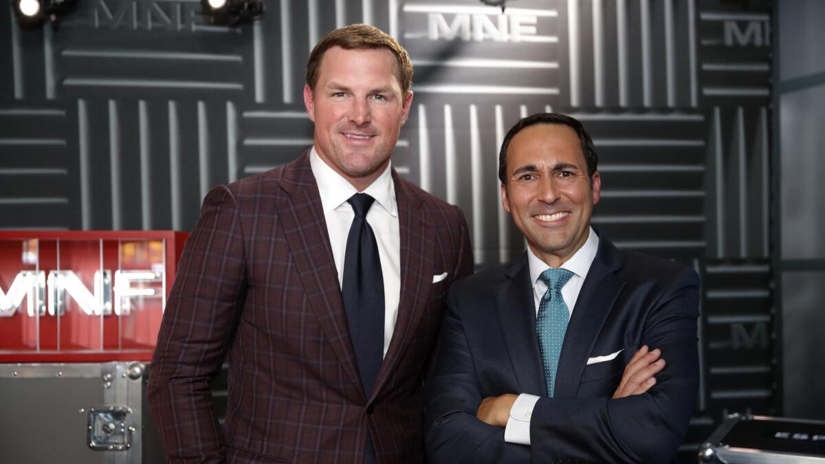 Former NFL player and analyst Jason Witten, left, and play-by-play commentator Joe Tessitore pose for a photograph before their ESPN telecast of a preseason NFL football game between the Washington Redskins and the New York Jets.