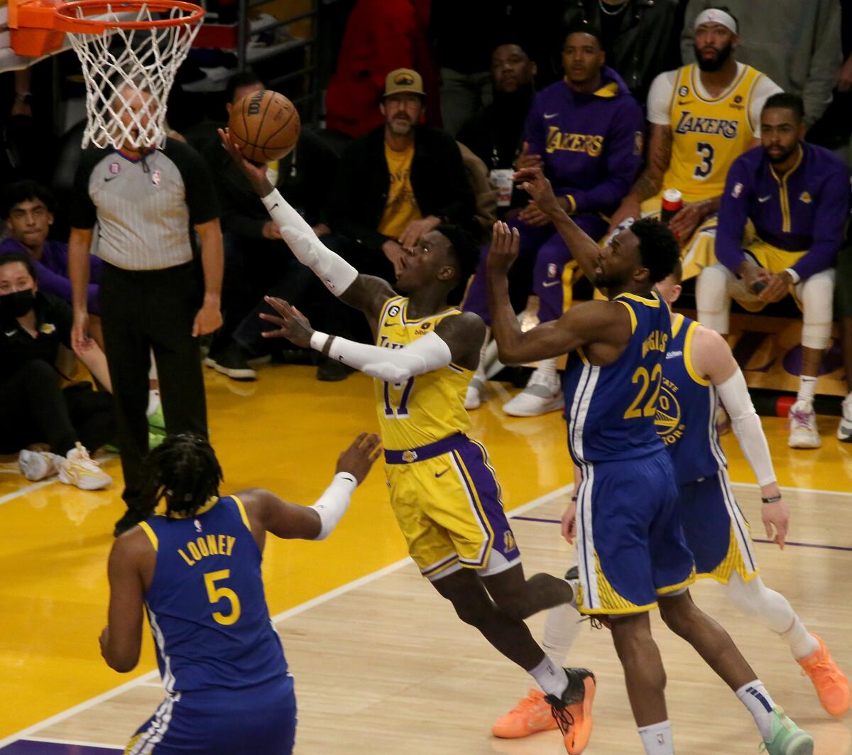 Lakers guard Dennis Schroder elevates past Warriors defenders for a layup during Game 4.