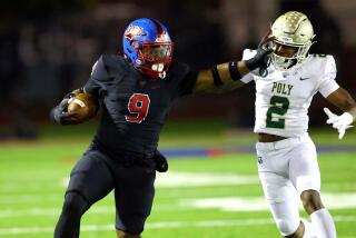 Gardena Serra's Cincere Rhaney gives a stiff arm to Long Beach Poly's Donovan Turner.