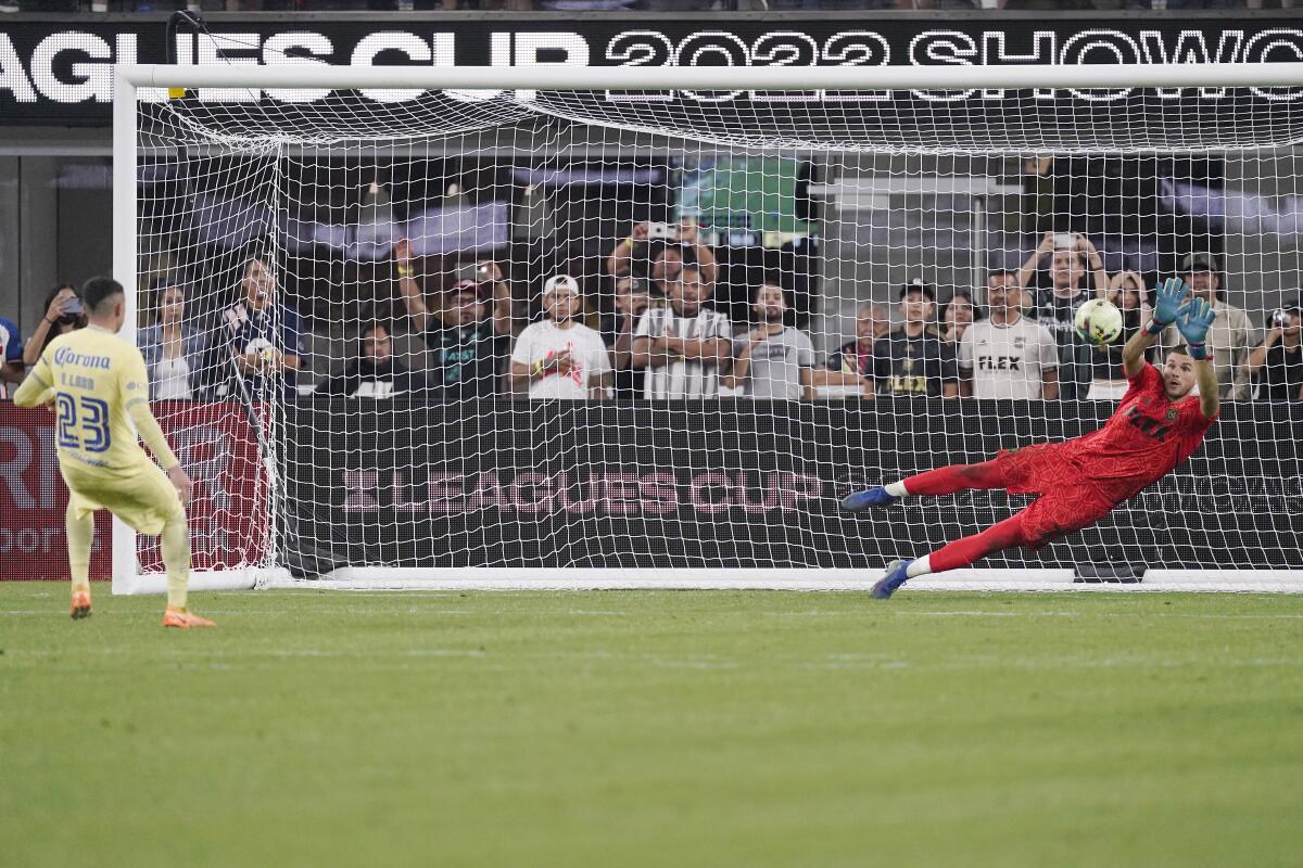 Club América midfielder Emilio Lara scores on LAFC goalkeeper John McCarthy.