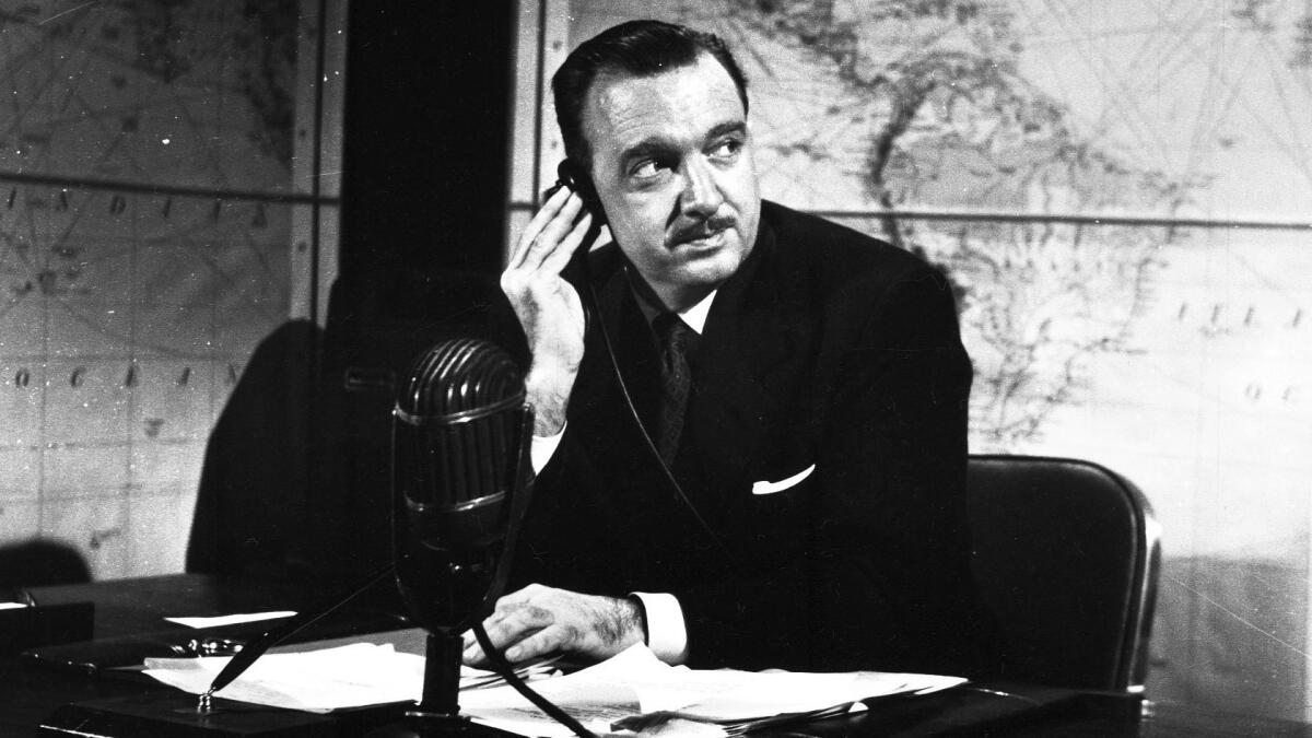 Walter Cronkite sits at his desk during the CBS Television series "You Are There" on Feb. 3, 1953.