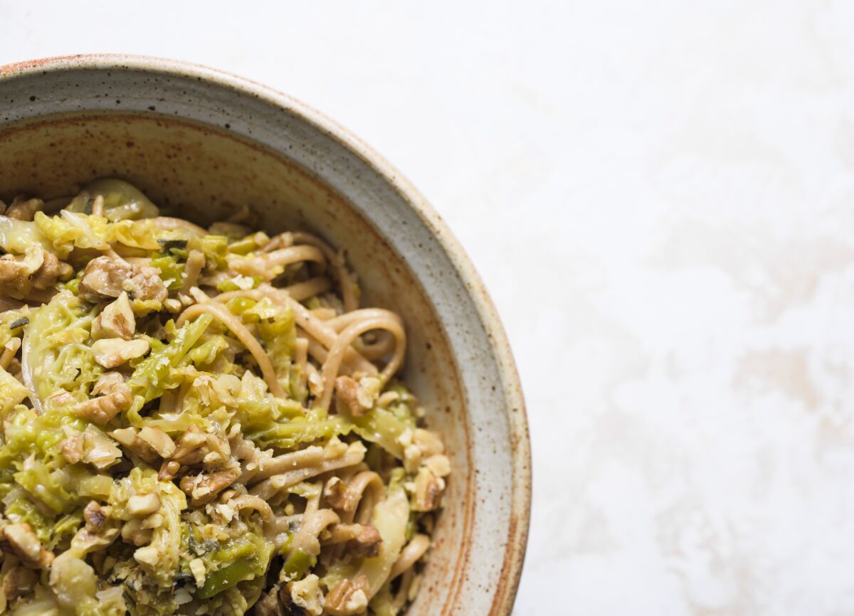 This image released by Milk Street shows a recipe for Whole-Wheat Fettuccine with Leeks, Cabbage & Gruyere. (Milk Street via AP)