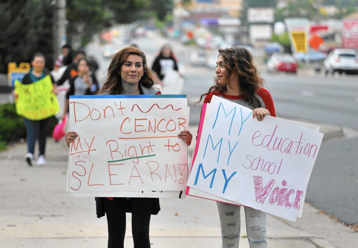 Students Andrea Colmenero, left, and Adriana Gonzales join a march in Edgewater, Colo., on Sept. 29 against a proposal to change the U.S. history curriculum.