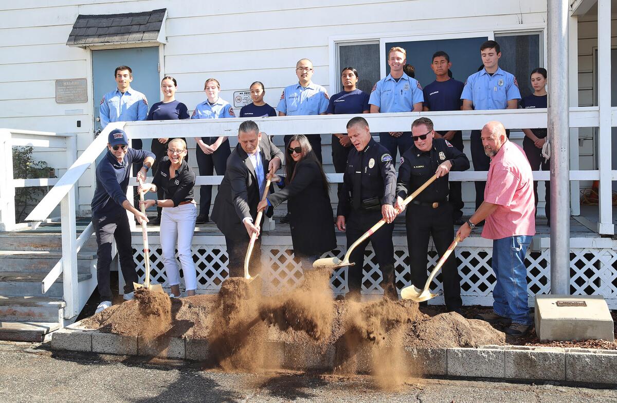 City officials break ground for the new Joint Youth Training Center backed by a crew of police and fire explorers.