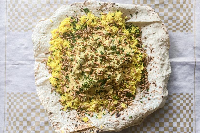 Mansaf, festive Jordanian lamb in yogurt over a bed of rice and bread.
