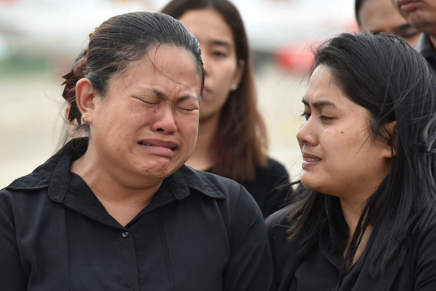 Family members grieve during a ceremony for Saman Gunan, who died in the rescue effort at Tham Luang cave.