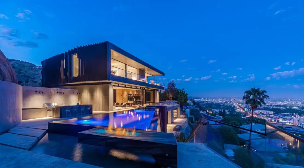 Newly built, the ultra-modern residence spans three stories with five bedrooms, six bathrooms and amenities such as a movie theater and game room.