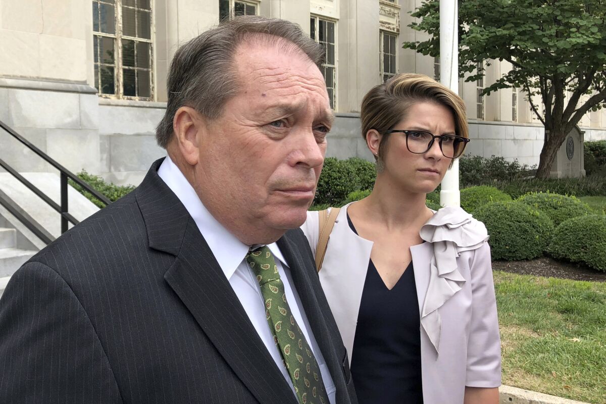FILE - In this Sept. 12, 2018, file photo, Jerry Lundergan, father of Kentucky Secretary of State Alison Lundergan Grimes, leaves the federal courthouse with his attorney Whitney True Lawson, in Lexington, Ky. A federal judge ruled that a former Kentucky Democratic Party chair, Lundergan, must report to prison next month on campaign finance charges. The Lexington Herald-Leader reported Wednesday, Oct. 6, 2021, that Jerry Lundergan was ordered to go to prison Nov. 30 after the 6th Circuit Court of Appeals upheld the 74-year-old’s conviction and rejected a motion to suspend the judgment. (AP Photo/Adam Beam, File)