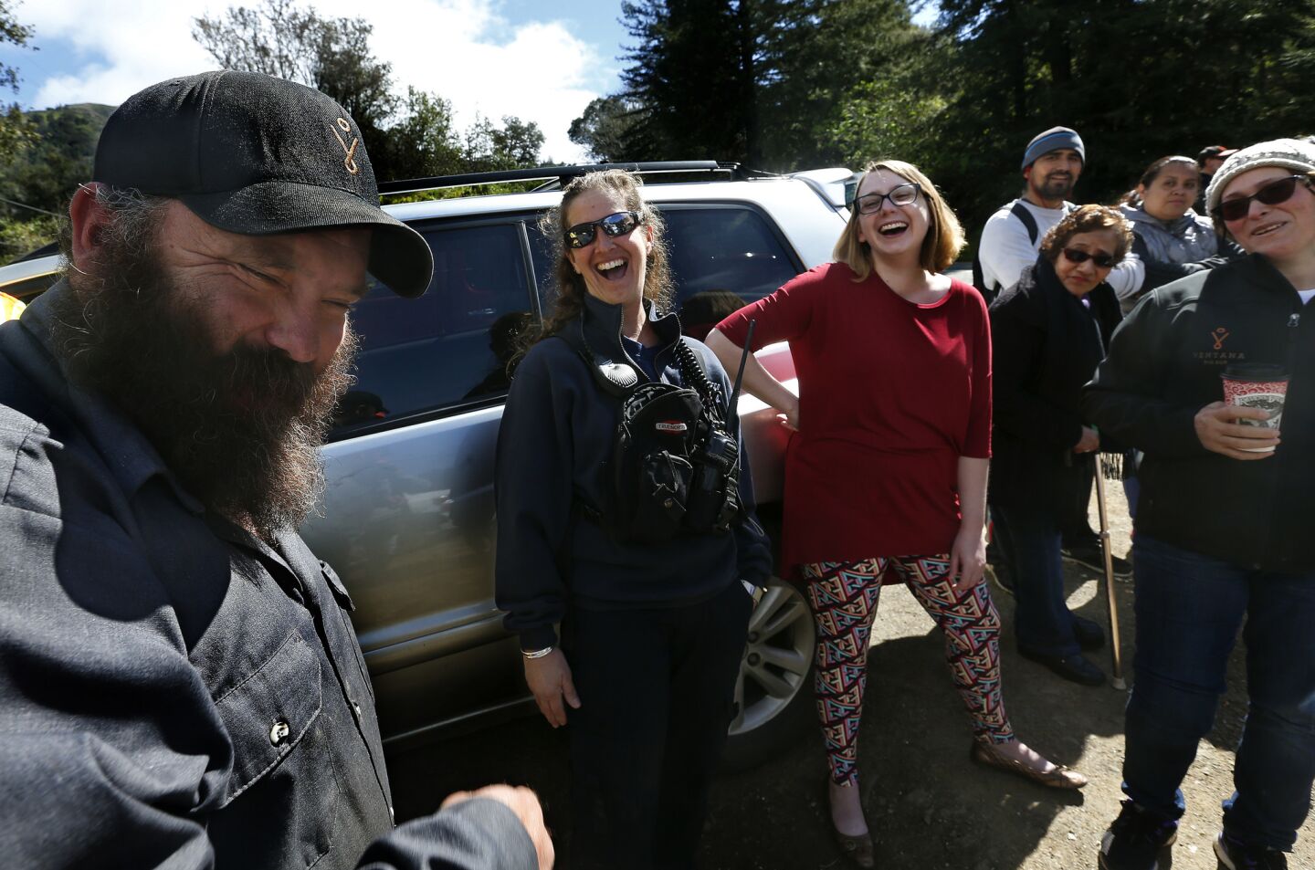 Jeannie Alexander, second from left, a medical captain with the Big Sur Volunteer Fire Brigade, enjoys a moment with other residents after she playfully touched the beard of Josh Case, left, an employee at the Ventana Inn & Spa, during a gathering of townspeople near Pfeiffer Big Sur State Park.