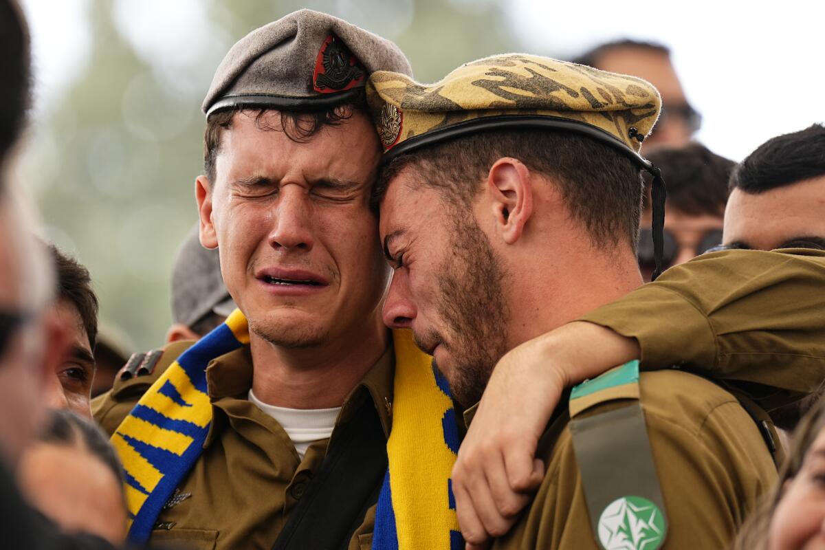 Soldiers and friends of an Israeli soldier killed in battle mourn his death.