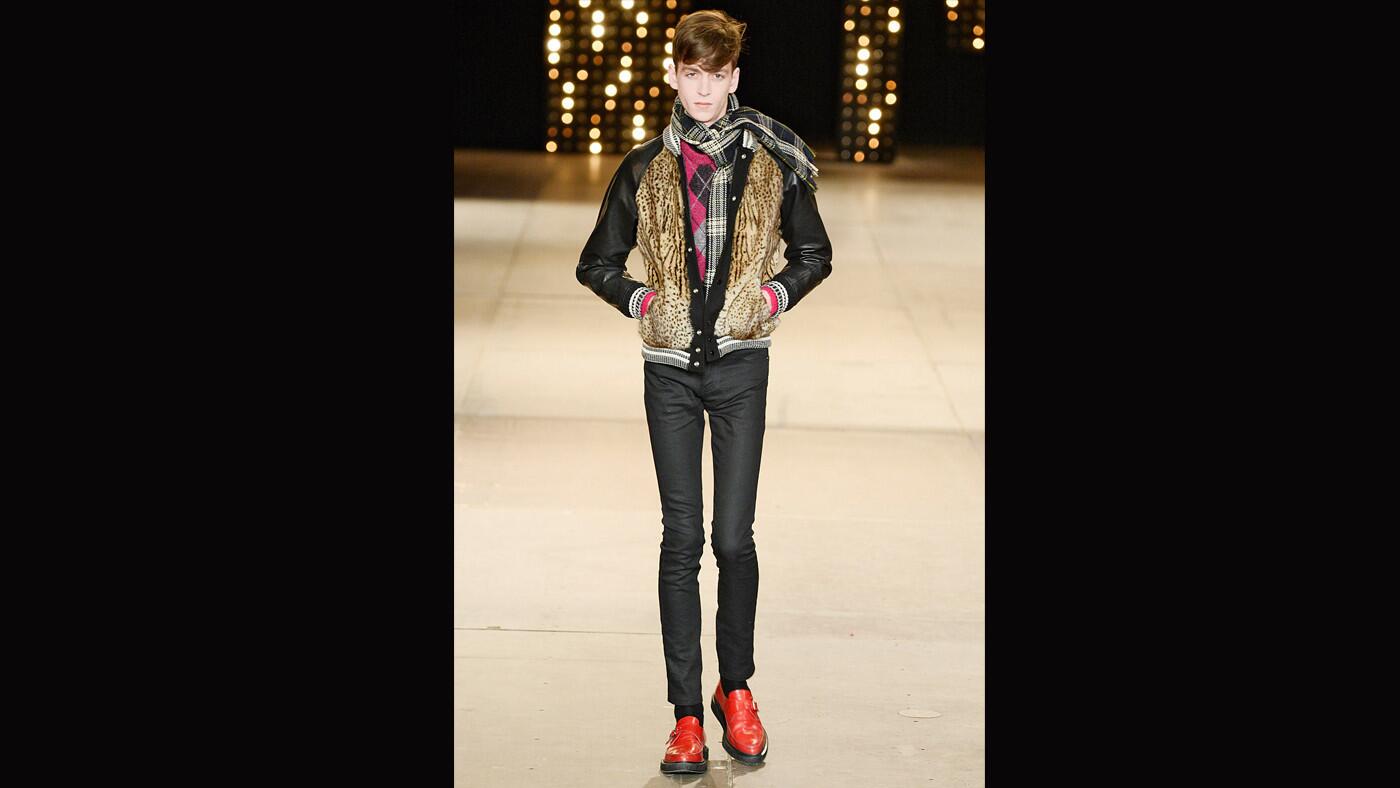 A model walks the runway at the Saint Laurent Autumn Winter 2014 fashion show during Paris Menswear Fashion Week.