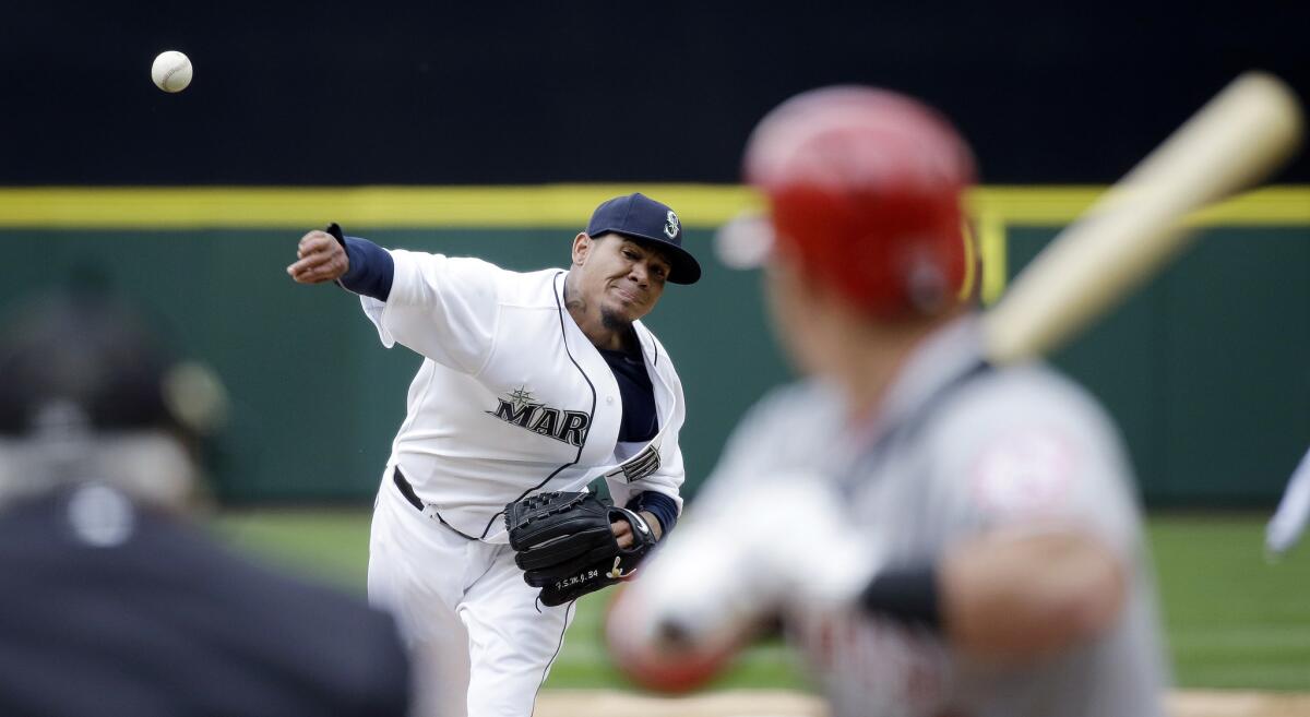 Mariners starting pitcher Felix Hernandez throws against the Angels on opening day in Seattle.