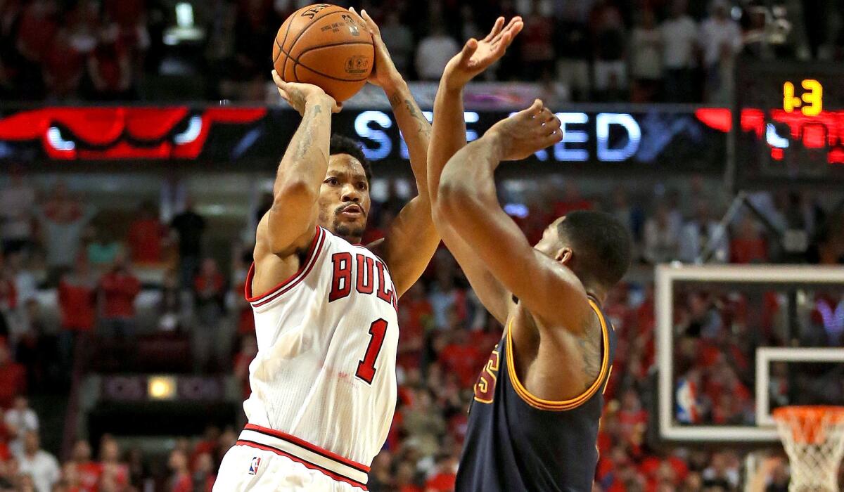 Bulls point guard Derrick Rose (1) takes the game-winning shot over Cavaliers forward Tristan Thompson in Game 3 of their first-round playoff series Friday night in Chicago.