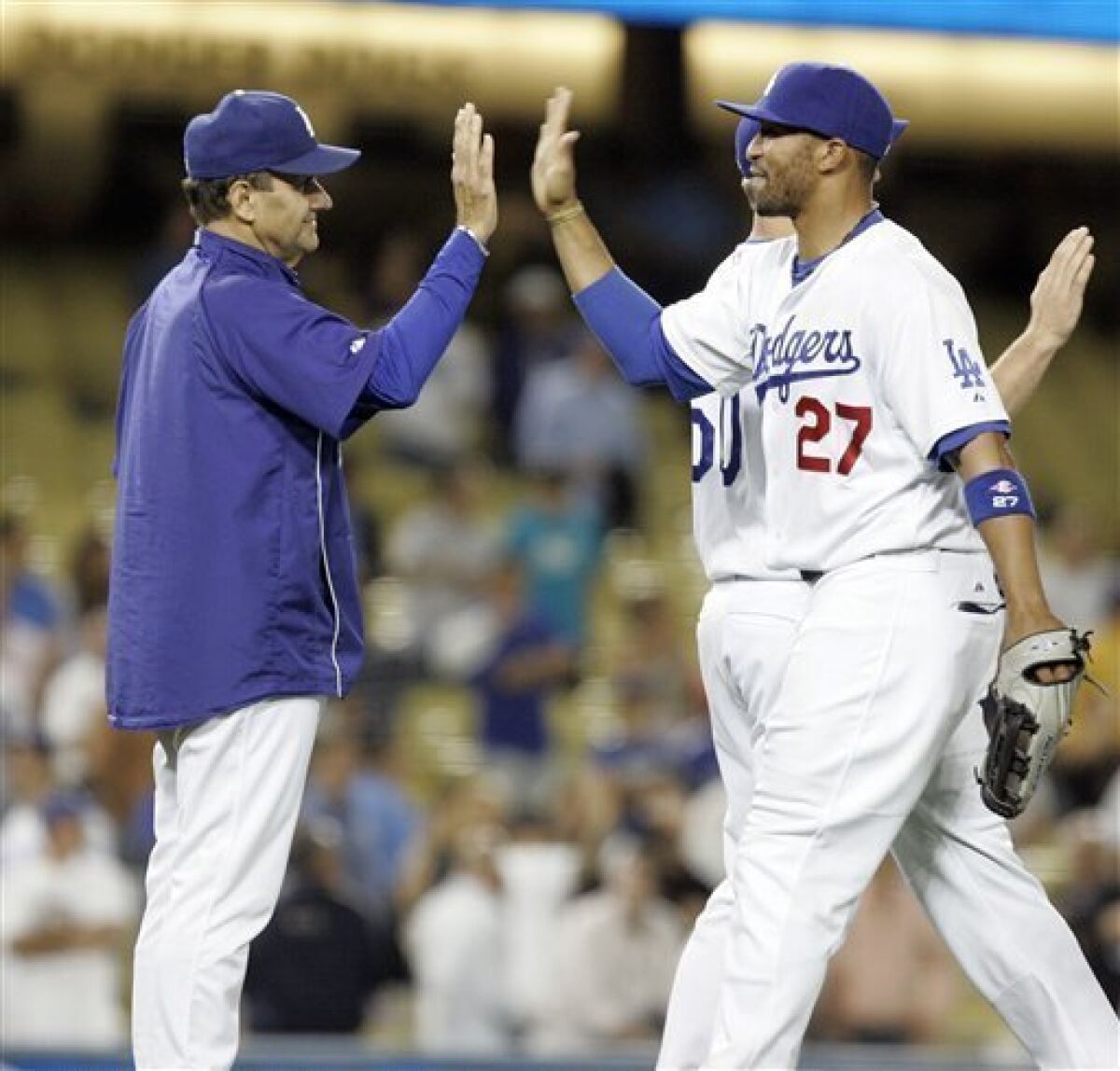 Los Angeles Dodgers manager Joe Torre, left, congratulates Matt Kemp (27) at the end of the game against the Washington Nationals in their record setting thirteenth consecutive home stand win in a baseball game in Los Angeles, Wednesday, May 6, 2009. The Dodgers won 10-3. (AP Photo/Lori Shepler)