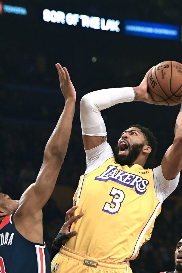Lakers forward Anthony Davis puts up a shot over Wizards forward Rui Hachimura during the first half of a game Nov. 29 at Staples Center.