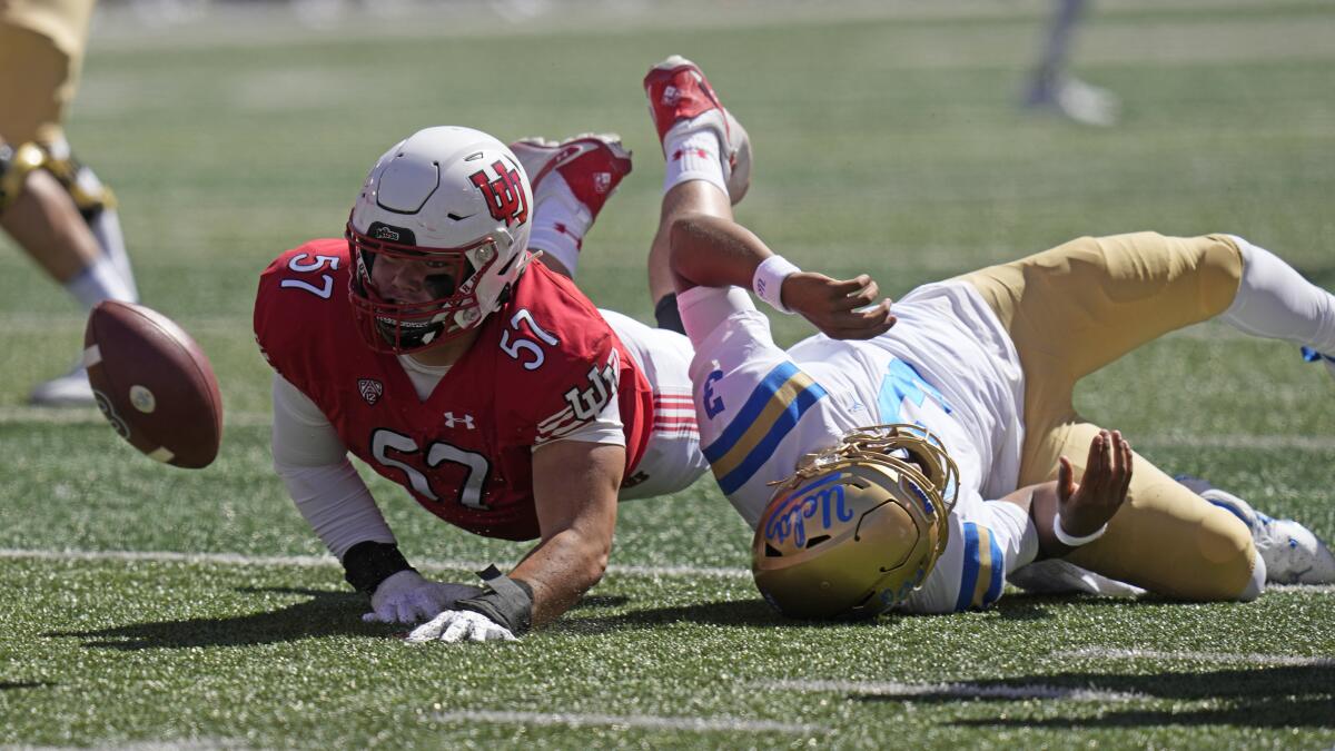 UCLA quarterback Dante Moore (3) fumbles the ball as he is hit.