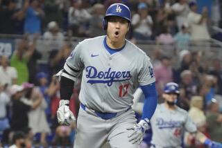 Dodgers' Shohei Ohtani reacts with his mouth wide open while running the 
bases after hitting his 50th home run of the year