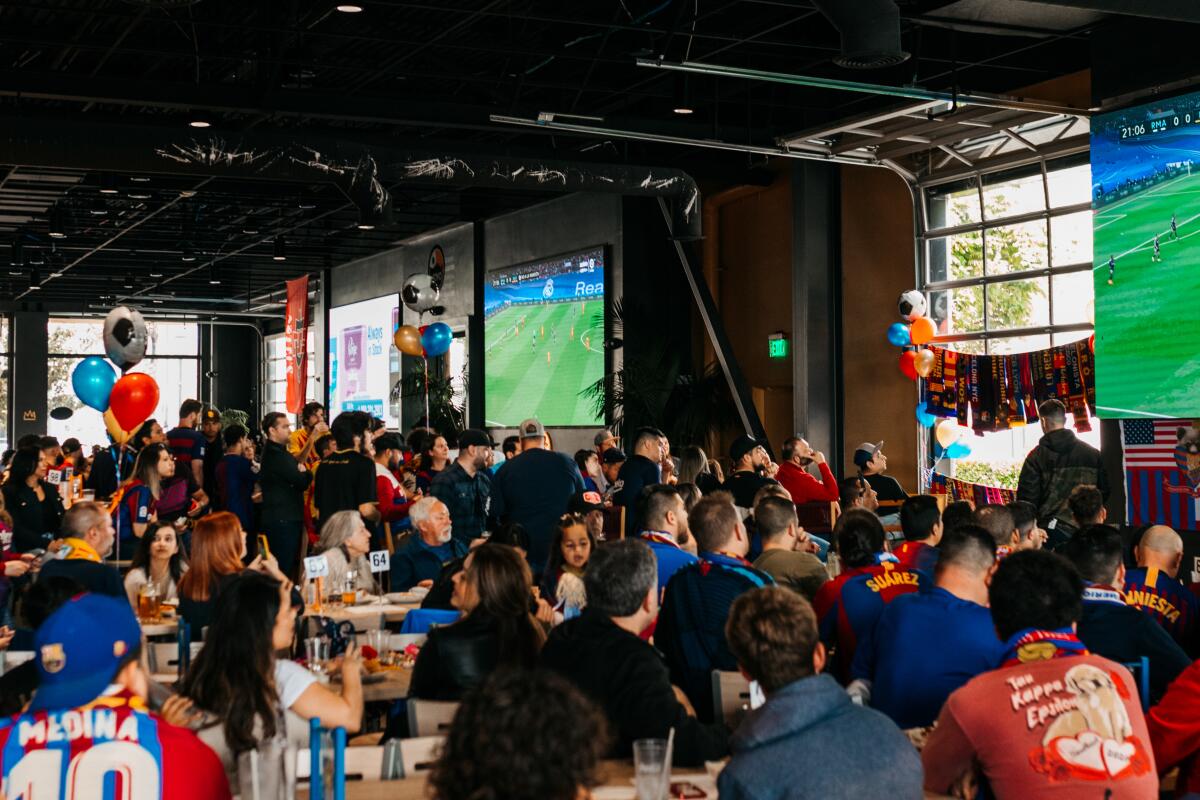 Fans of Barcelona FC look on at a watch party at Novo Brazil Brewing restaurant.