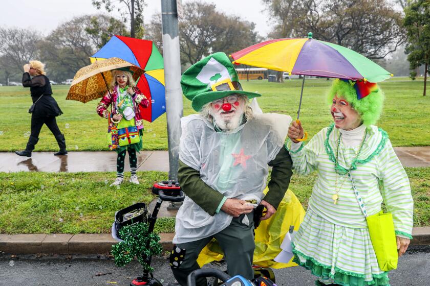 SAN DIEGO, CA-March 11: Daniel Wheel AKA "Uncle Rusty"and Terry "Sunshine" Ghianni watch the parade during the 41st Annual St Patrick's Day Parade along 6th Aveue on Saturday, March 11, 2023.(Photo by Sandy Huffaker for The San Diego Union Tribune)