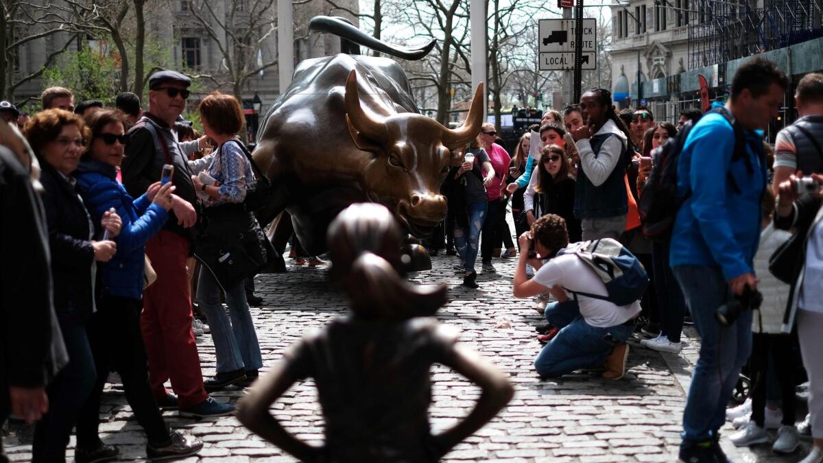 "Fearless Girl," in the foreground, faces "Charging Bull" in downtown Manhattan.