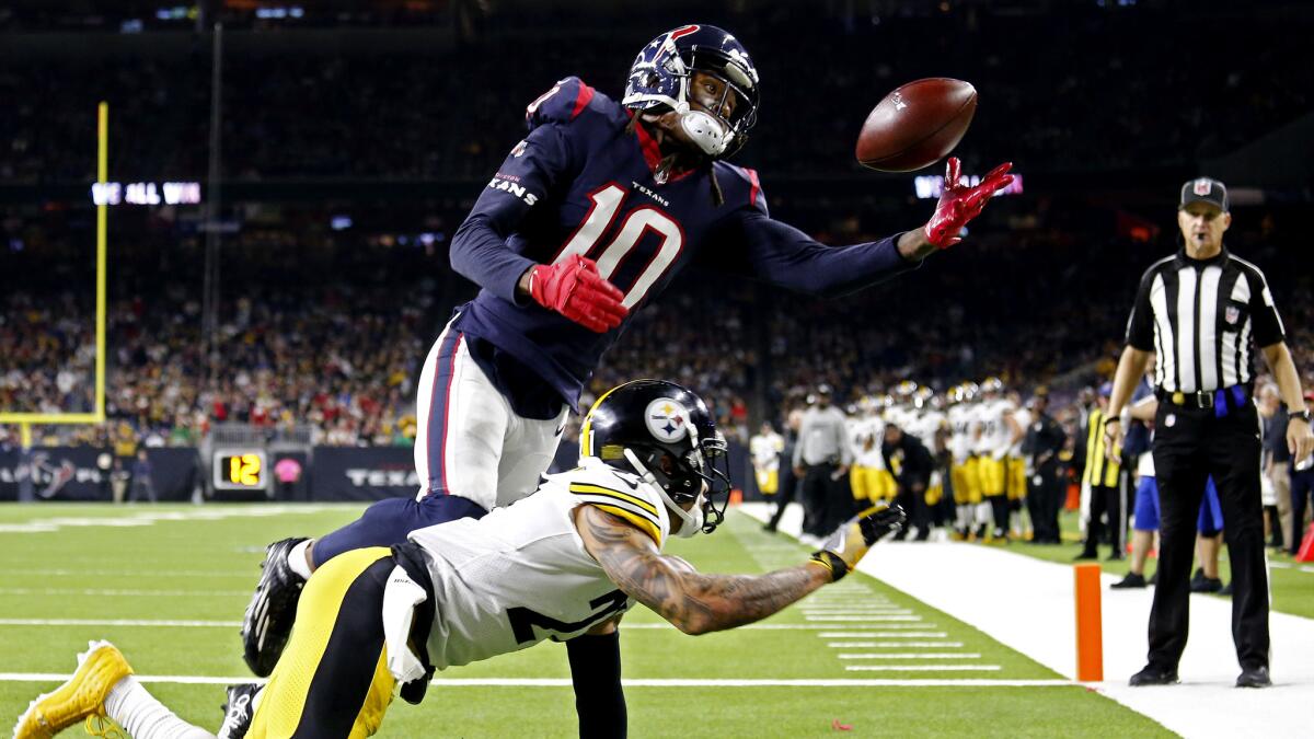 Texas receiver DeAndre Hopkins (10) makes a juggling, one-handed catch against Steelers cornerback Joe Haden during the second half Monday.