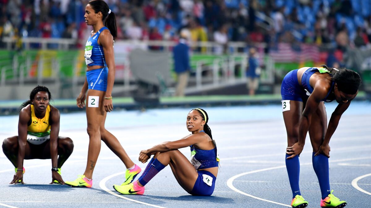 American sprinter Allyson Felix, second from right, watches the scoreboard to see her placing after the women's 400 meters on Monday night.