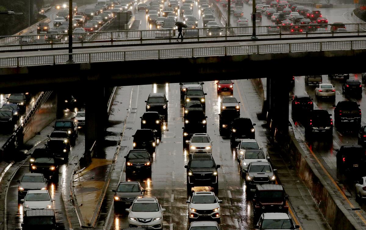 Traffic slows to a crawl on the rain-slicked Harbor Freeway in downtown Los Angeles during an atmospheric river. 