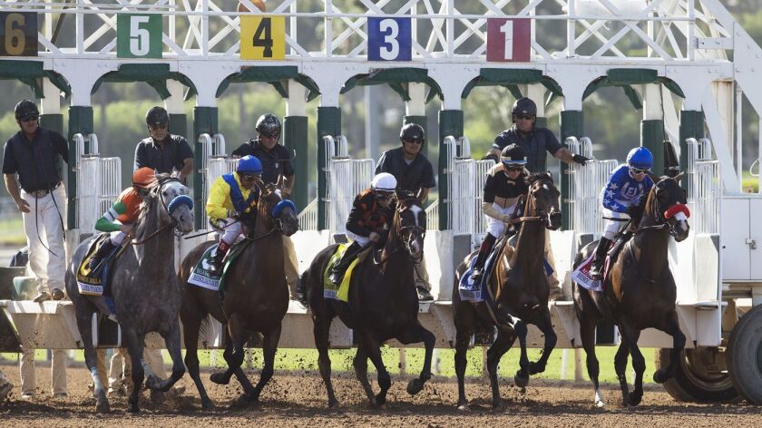 Jockeys and horses leave the gate at the start of the Grade I $400,000 Beholder Mile horse race on June 2, 2018, at Santa Anita in Arcadia.